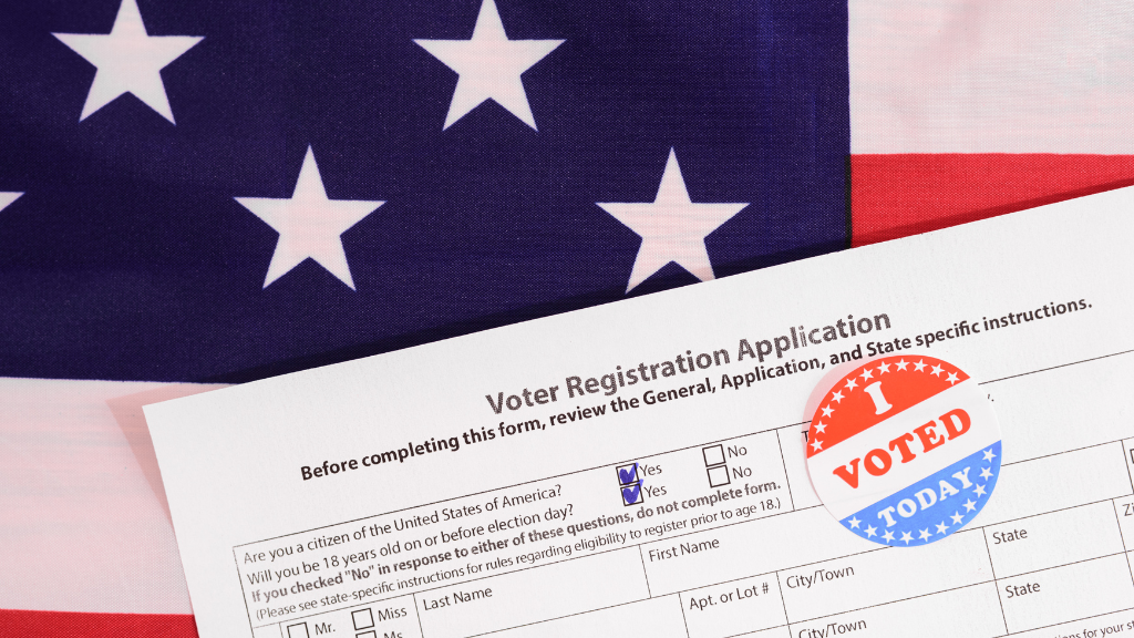 Image of American Flag with a US Voter Registration application laying on top of flag with two "yes" boxes marked by blue check marks and an "I Voted Today" stick on the on the application.